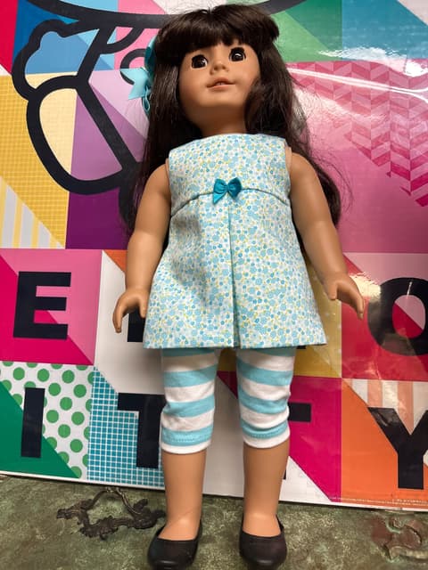 Brunette Doll In Blue Floral Tunic And Striped Leggings