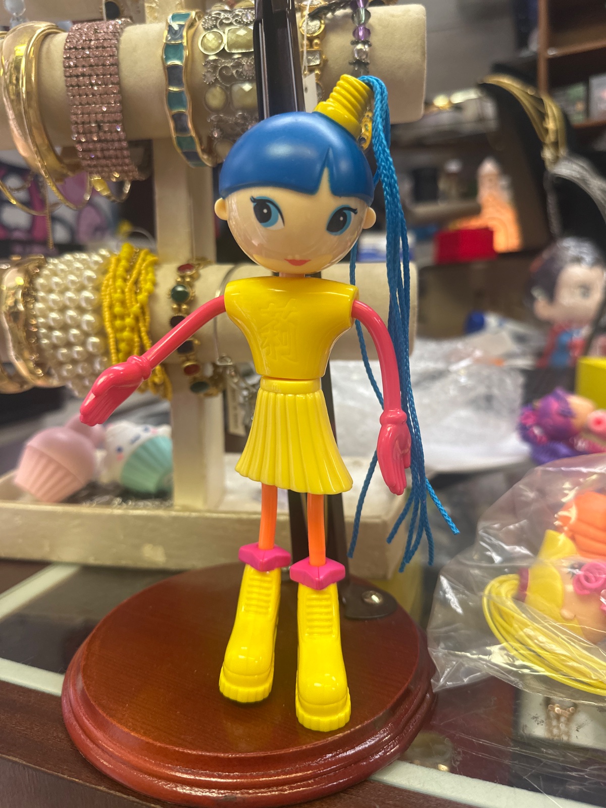 Yellow Vinyl Pop Doll With Blue Ponytail